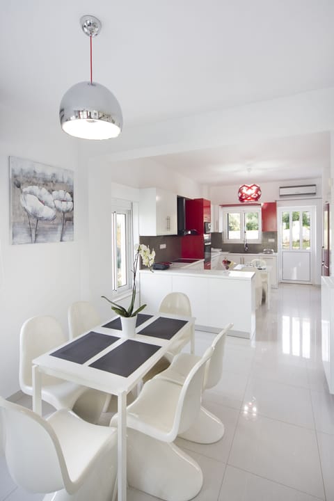 One of the dining tables and the kitchenette in the background