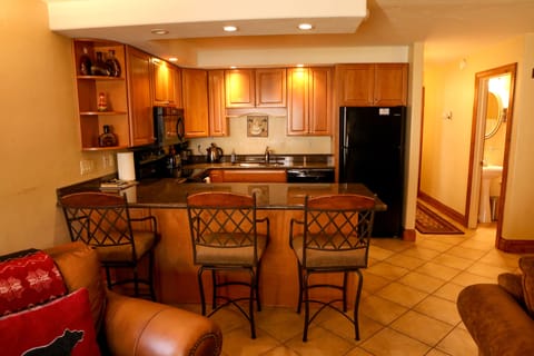 Newly renovated/stocked kitchen with granite countertops and bar seating for 3