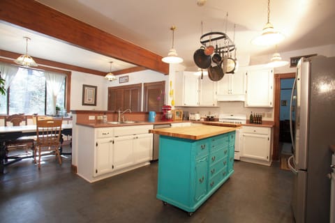 Kitchen view from entry, with view of door leading to parlour and other rooms.