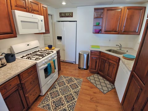 Stocked kitchen with cookware, dishes, coffee pot, fridge w icemaker, etc.