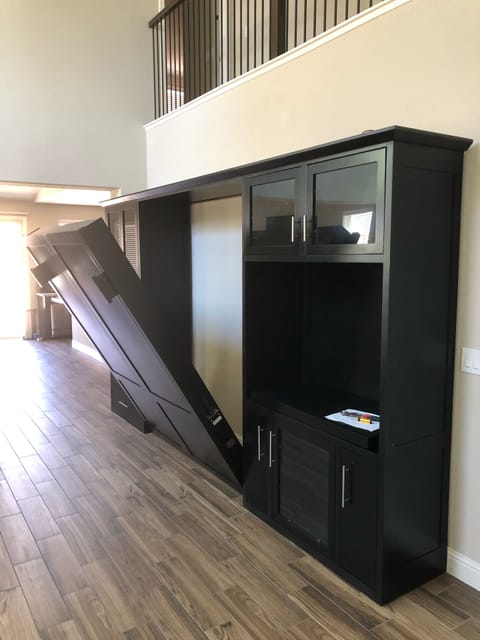 Wall bed unit in living room. Queen size mattress. Sleeps two. 