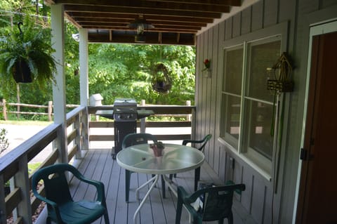 Large deck with dining table with seating for 2, gas grill, dog gate