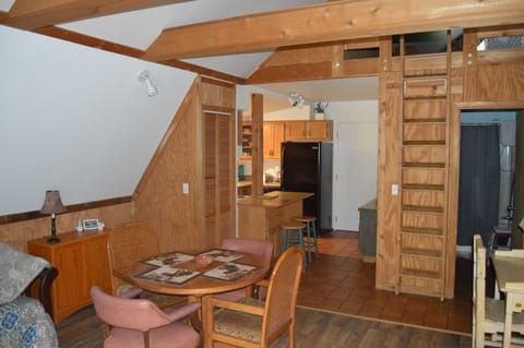 View to dining area, kitchen, and loft entrance