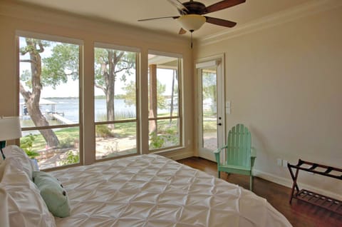 Downstairs Primary Bedroom with lake view, outdoor access, and en suite bathroom