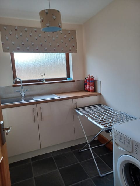 Separate Utility room with washing machine and electric clothes drier. 