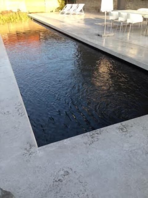 Large terrace with sunbeds and natural pool