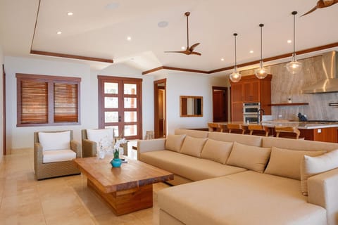 Unwind in the open-concept living space featuring soaring ceilings and plush, stylish seating.