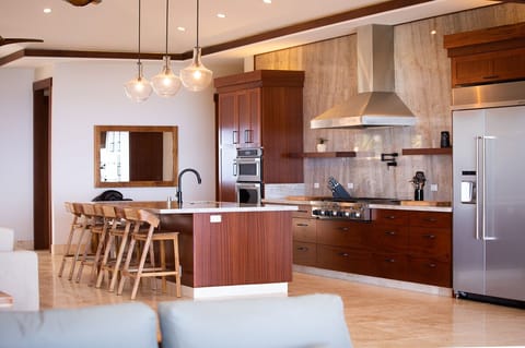 Prepare gourmet meals in a fully equipped kitchen with a six-burner cooktop and sleek finishes.