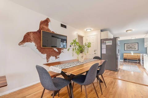 - Modern dining room with a live edge wood table, seating for six, and a bold wall art display
- Bright and airy with natural light and stylish decor accents
- Great for family meals, game nights, or remote working

