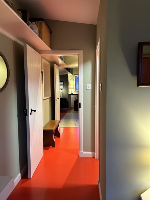 Hall past cloakroom and utility into kitchen