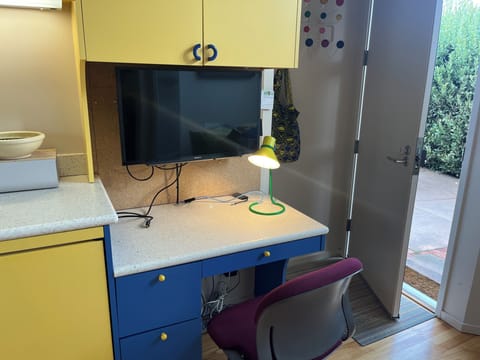 Desk with monitor at end of kitchen counter, back door,
