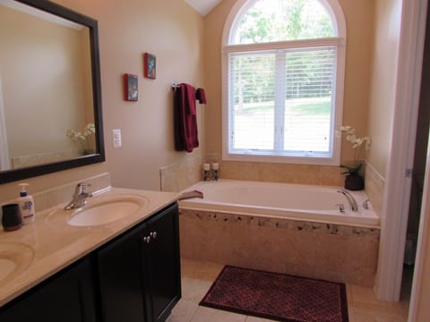 Master bath with soaking tub and separate shower.