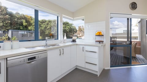 kitchen opens to back deck with outdoor fireplace