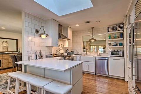 Boasting sleek white tile & stainless steel appliances, this kitchen is a dream.