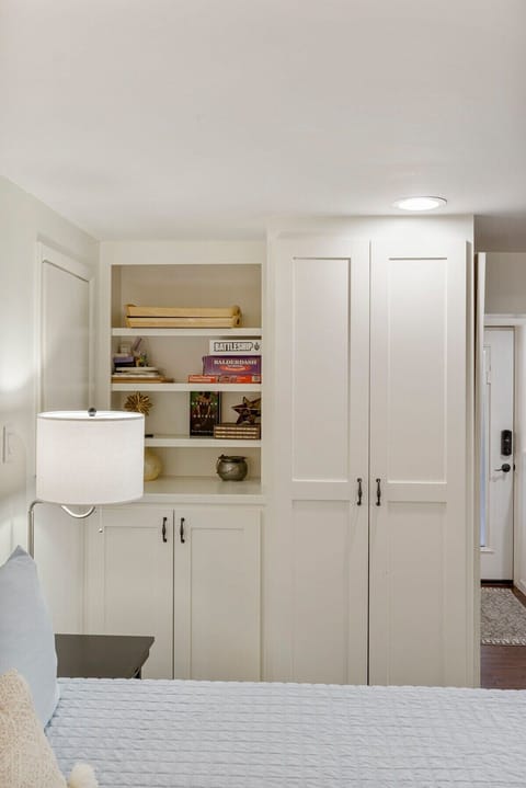 The closet houses a pack-and-play, ironing board, and high chair.
