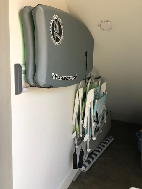 Storage space in unit has 2 boogie boards, 2 beach chairs, an umbrella, cooler
