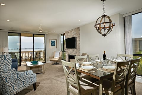 The dining and living areas of Coastal Cottage look down the beach to the Oceanside Pier.