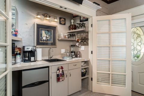 Coffee bar area W/frig, wine glasses, ice bucket, dishes, silverware, etc