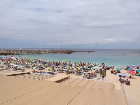 On the beach, sun loungers, beach towels