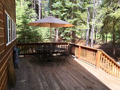 Large deck with two tables and umbrellas