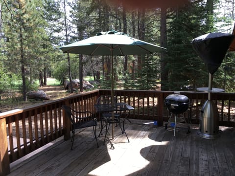 Large deck with two tables and umbrellas