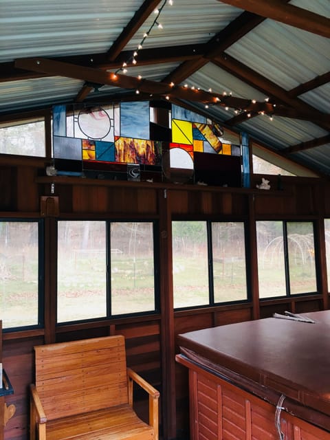 Inside view of Gazebo where hot tub is located adorned with stain glass windows