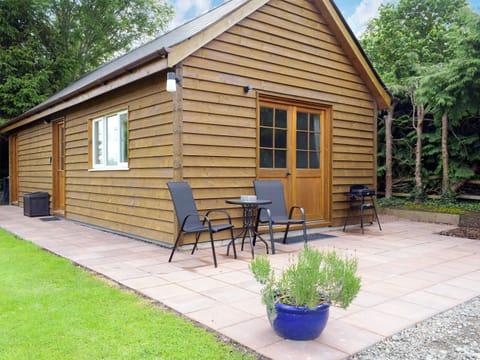Patio with garden furniture and barbecue | Walkers Lodge, Dormington, near Hereford