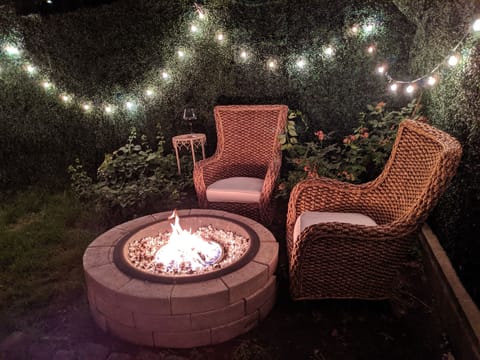 Lounge area by fire pit amongst the string lights