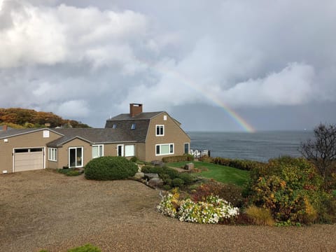 Rainbow over Breakwater House and ocean