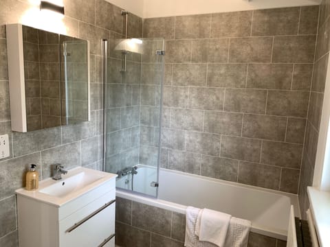 Combined shower/tub, hair dryer, towels, soap