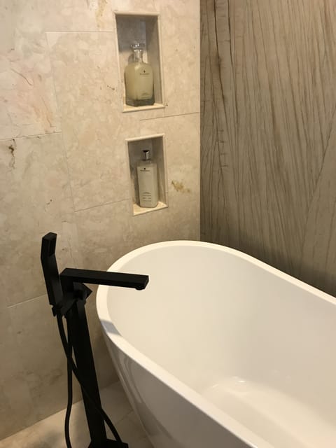 Bathtub, hair dryer, towels, soap