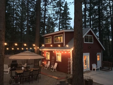 Outdoor Entertainment Area with Fireplace and Cozy Night Lighting