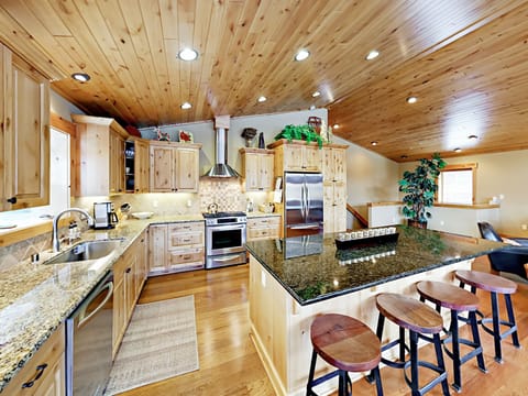 Well equipped chef's kitchen with stainless steel appliances, large pantry