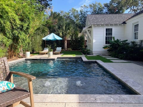 Gunite pool with bubblers on ledge and lounge areas in backyard paradise!