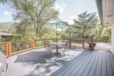 Back Deck is surrounded by foliage and a view of the mountains.