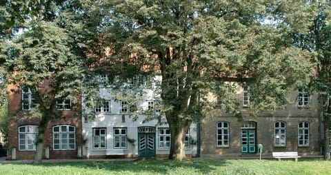 View on the historical house in the summer. Directly in front of the canal.