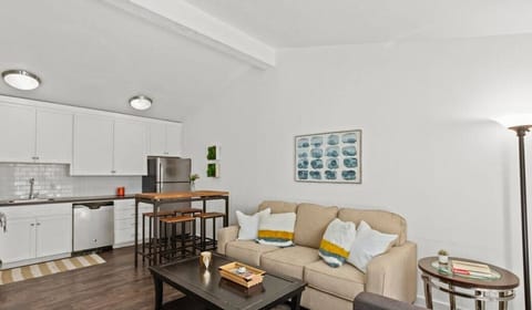 Living room with sleeper sofa and smart TV open to the kitchen