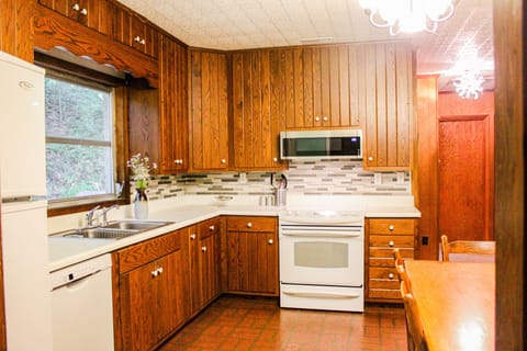 Kitchen with updated tile and appliances.