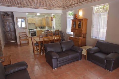 The open living/dining room with new couches and chair