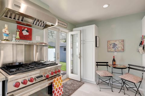 Kitchen has chef grade appliances and a bistro table