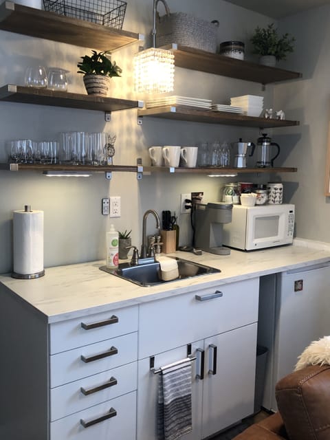 Kitchenette - includes a hot plate, microwave, toaster, and cooking utensils.