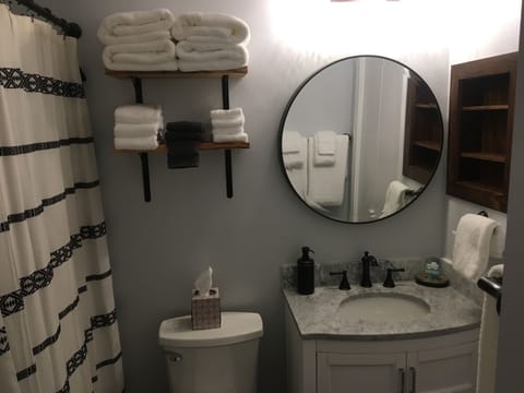 Master bathroom with custom wood shelves for plush towels and toiletries