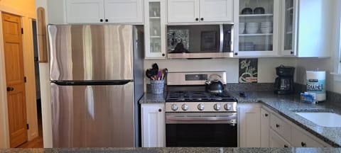 Prepare meals with ease using the modern stainless-steel appliances in the kitchen.