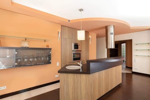 Kitchenette with oven and refrigerator. 