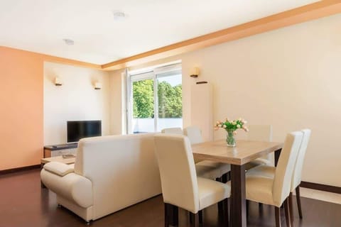 Large table with chairs for eating communal meals. 
