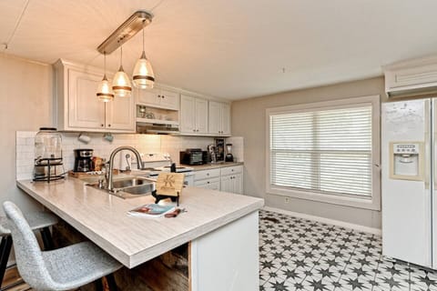 Kitchen is fully stocked with pots, pans, utensils, blender, toaster, microwave, spices, Alexa for music, and two bar stools.