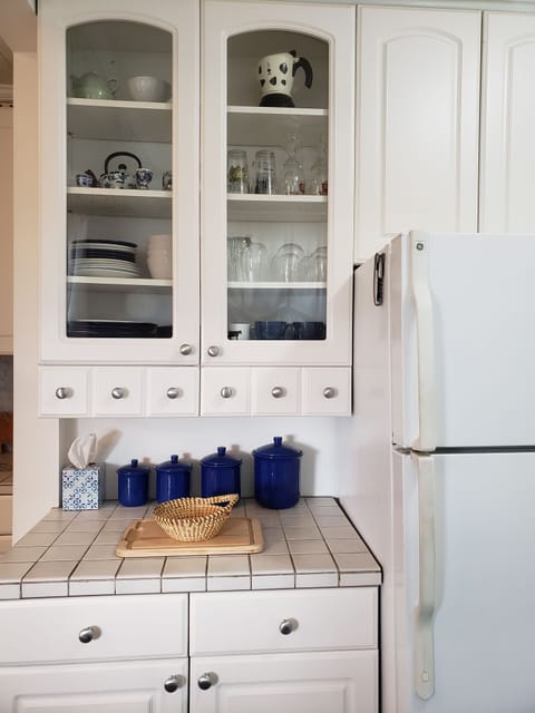 full fridge/freezer combo, lots of dishes, pots and pans, sharp knives, utensils