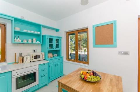 Kitchen with exit to the terrace overlooking the sea