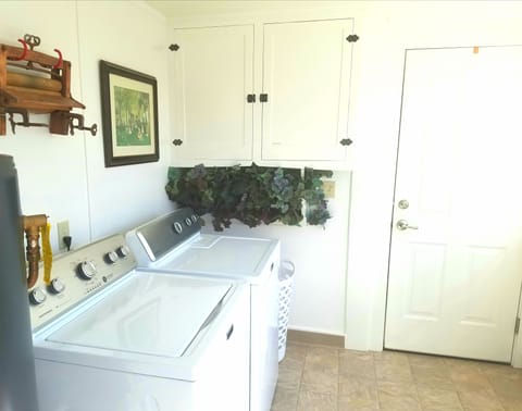Laundry room with washer and dryer and back door