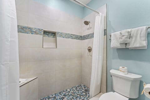 Tiled shower area with coastal color